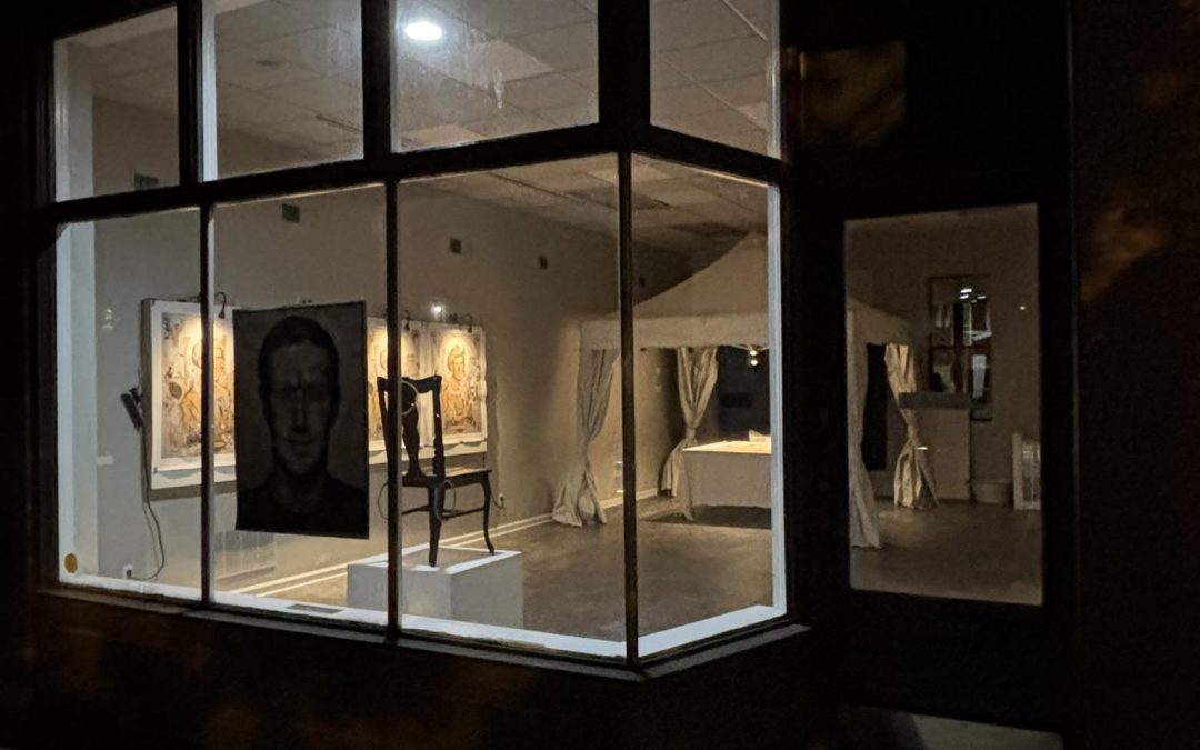 Cherokee Storefront at night with lights glowing showing art of David inside