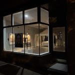 Cherokee Storefront at night with lights glowing showing art of David inside